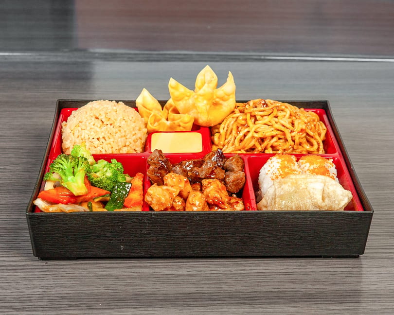A bento box filled with fried rice, lo mein, crab rangoons, mixed vegetables, beef, and sushi.